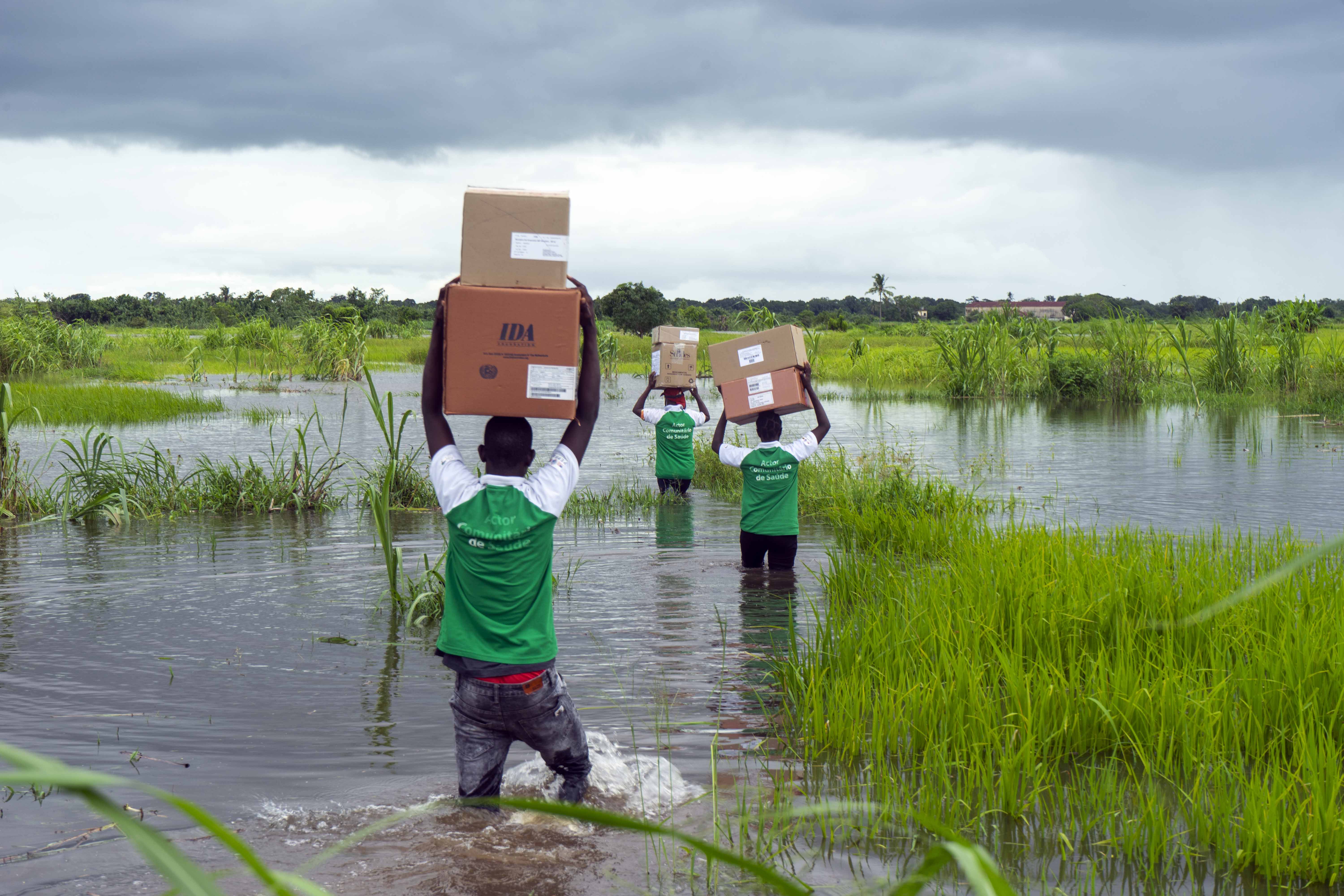 FGH peer educators transporting medications and supplies to areas inaccessible by car due to the rains